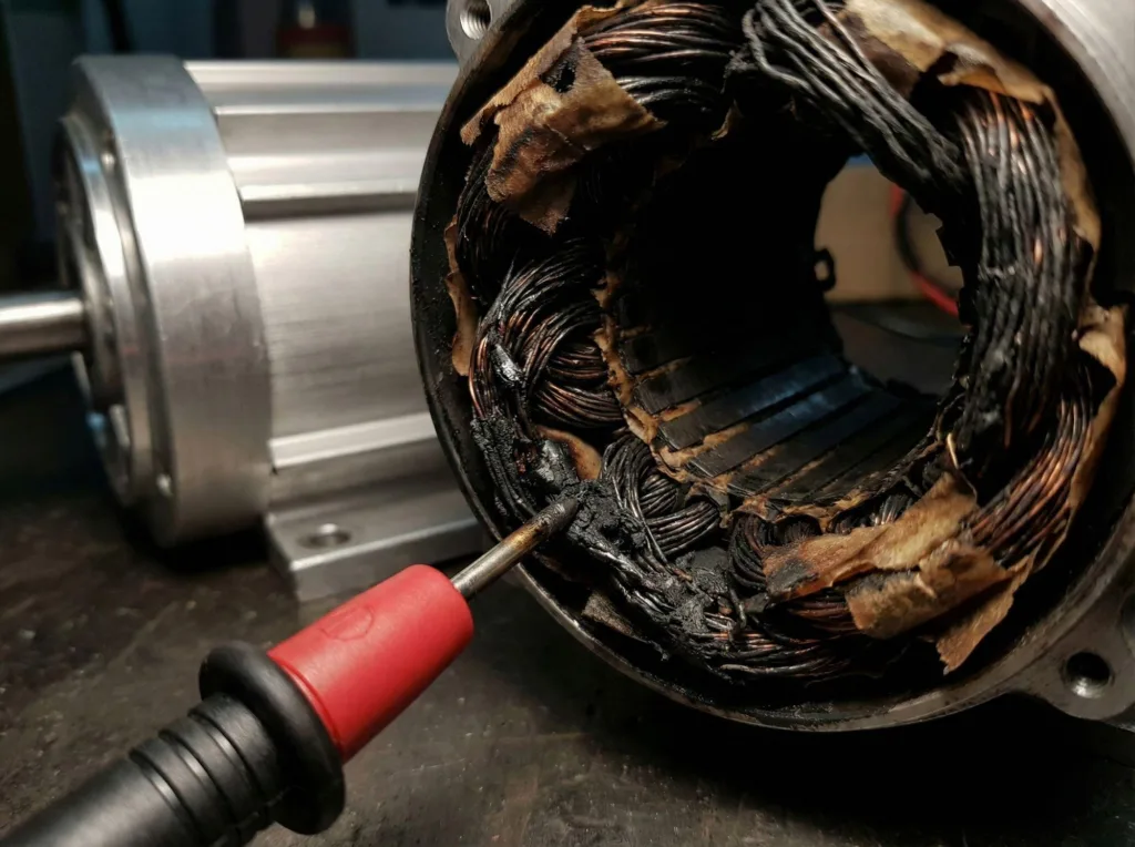 Burnt motor winding causing VFD motor failure despite normal amperage readings.